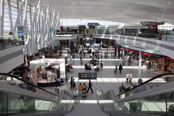 Tętniący życiem terminal lotnisko w Budapeszcie, z pasażerami spieszącymi do bram, sklepami i kawiarniami.